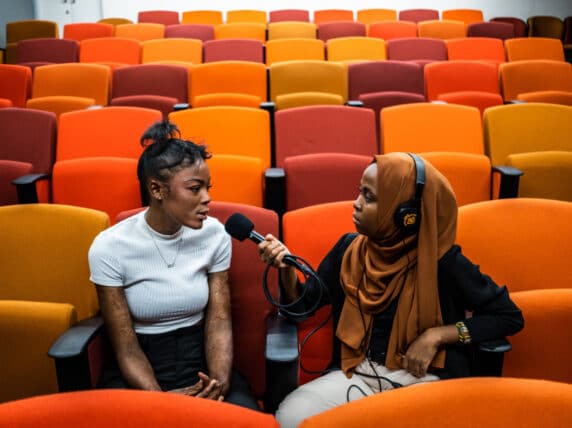 Tanzanian student Munira Kaoneka interviews burn victim survivor Thinasonke Kambi as part of a narrative non-fiction podcast training led by Radio Workshop in Cape Town.