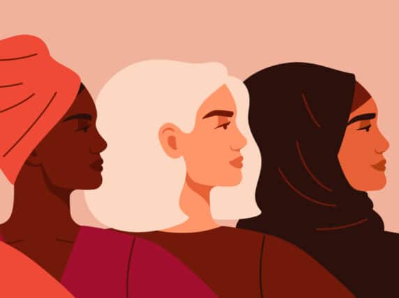 Portraits of Four women of different nationalities and cultures standing together. The concept of gender equality and of the female empowerment movement.
