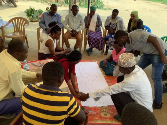 Drawing the 'River of Life', Refugees: Innovation, self-reliance and empowerment (RISE) programme in Uganda. Photo by Tricia Jenkins (InsightShare).