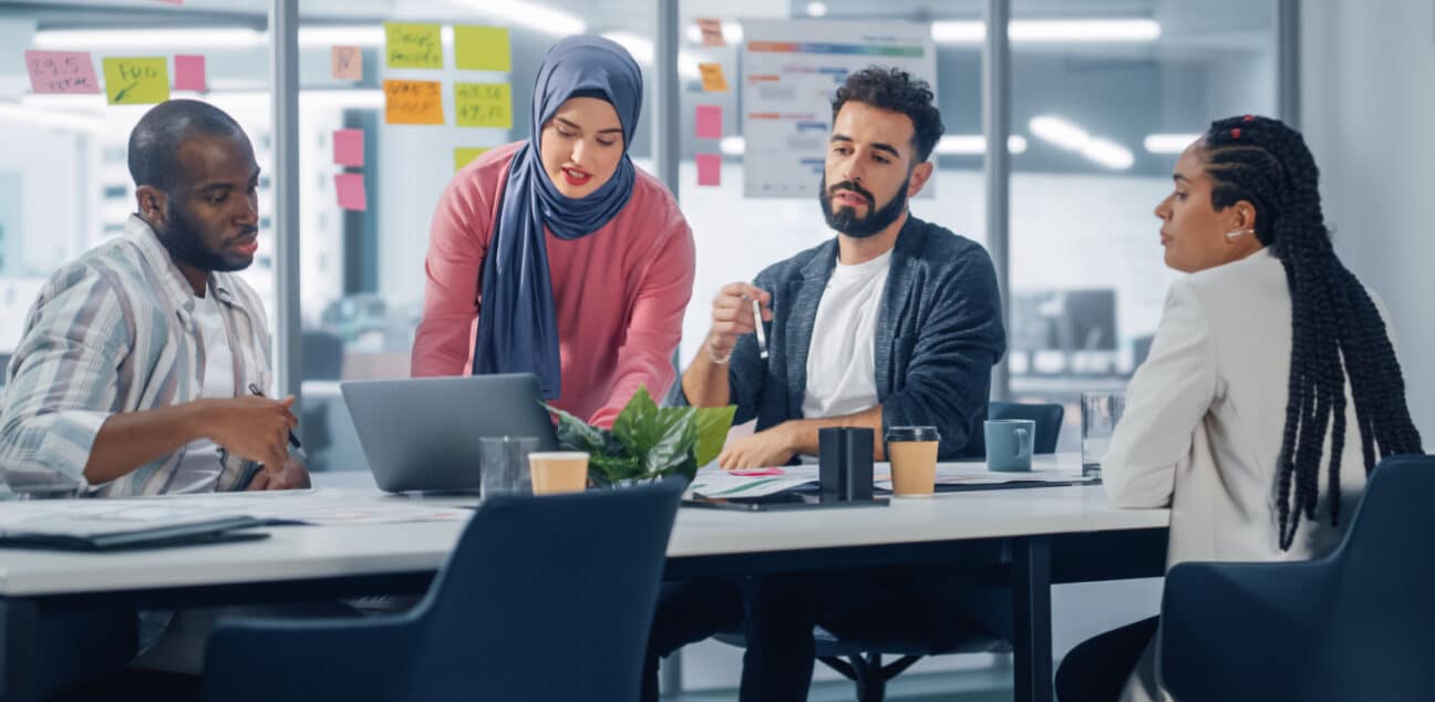 Group of people around a table with laptop