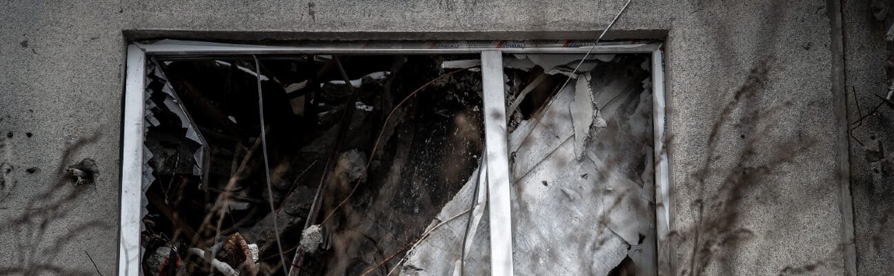 Broken window on a grey building. Credit: World Jewish Relief