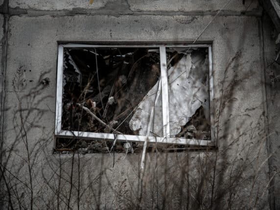 Broken window on a grey building. Credit: World Jewish Relief