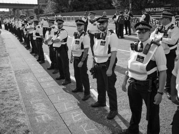 Police protect DSEI Arms Fair from blockade attempt. Credit: Alisdare Hickson