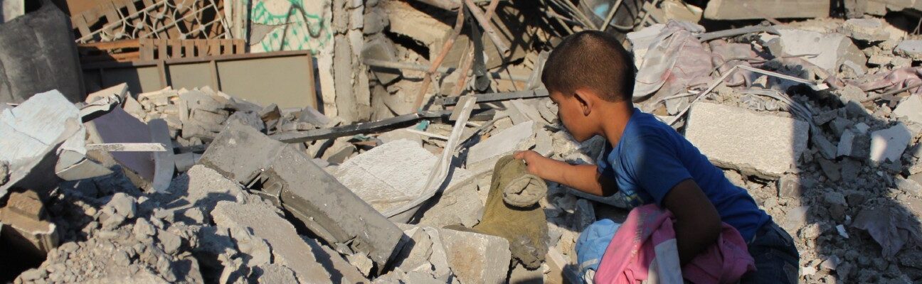 Boy in the rubble in Gaza. Credit: Salah Hosny