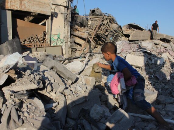 Boy in the rubble in Gaza. Credit: Salah Hosny