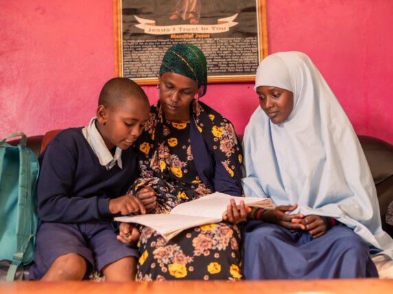 Safia Galgalo with her son Abudho and her niece Jilo check Abudho’s school work. Kenya spent $3.7 billion on external debt in 2023. If Kenya was able to invest its debt repayments into the education system, more children could be educated. Credit: PSAYS_PHOTOGRAPHY