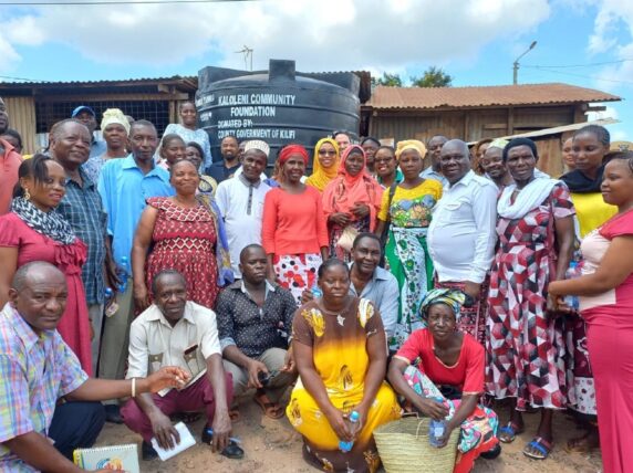 The Kaloleni Community Foundation gathers to celebrate their most recent achievement – the installation of a five-thousand-liter water tank. Photograph: AKF / Abdalla Dzimwenga.