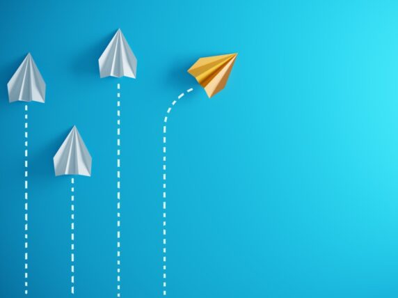Illustration of four paper planes, where the plane to the far right represents the deceleration/pivot of organisations