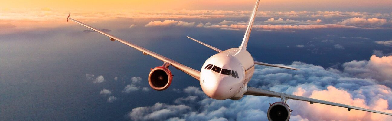 Airplane flying above clouds.