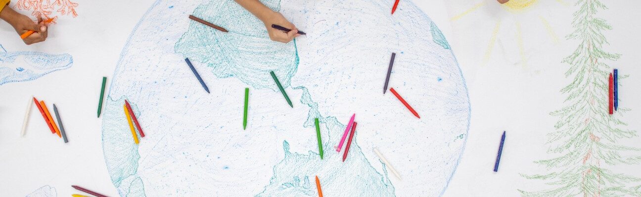 Children drawing a globe