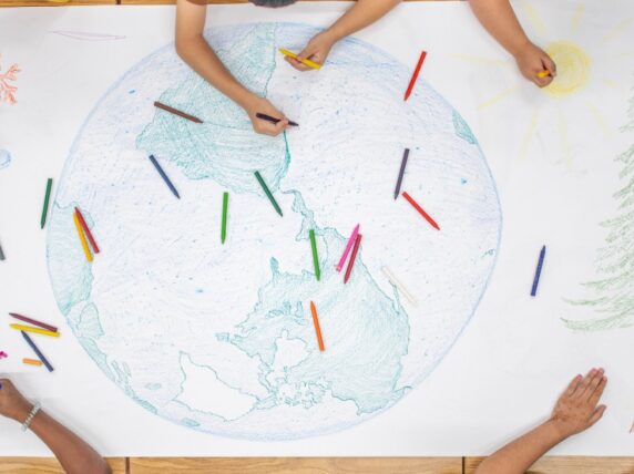 Children drawing a globe