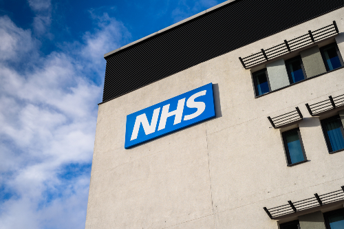 View of the NHS (National Health Service) logo at the Springfields Medical Centre in the centre of Warrington, Cheshire. Credit: Marbury