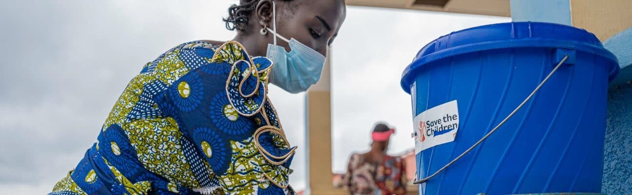 Marlene(25) washes her hands at a health centre following guidance on Ebola prevention. Credit: Save the Children