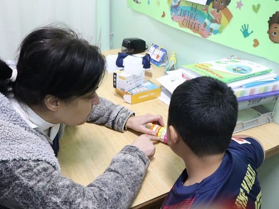 A Kids Alive therapist with a child. Credit: Kids Alive International