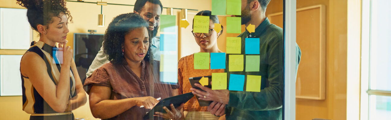 People collaborating in a meeting room/iStock